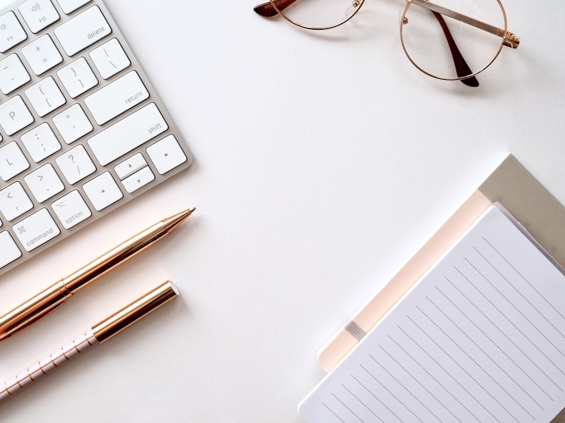 Elegant desk with gold pens and notebook